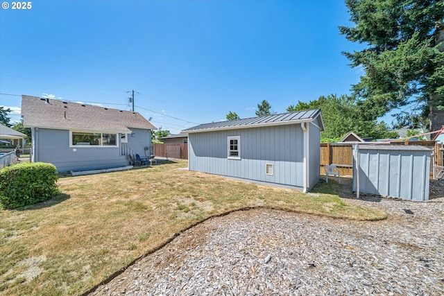 5246 SE 65th Ave, Portland, OR 97206 - back of house featuring a standing seam roof, a fenced backyard, a metal roof, and a shed