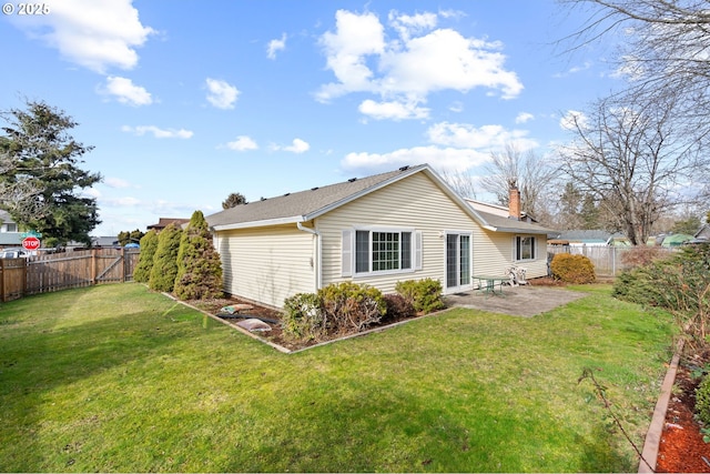 back of property featuring a yard and a patio area