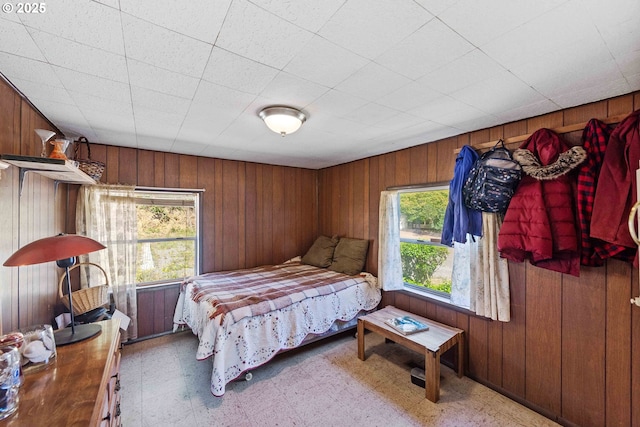 1387 Washington Ave, Coos Bay, OR 97420 - bedroom featuring multiple windows, wooden walls, and tile patterned floors