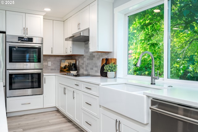 10014 NE 146th Ave, Vancouver, WA 98682 - kitchen featuring stainless steel appliances, exhaust hood, light countertops, white cabinetry, and recessed lighting