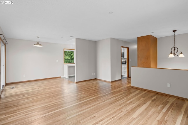 3707 NE 135th Ave, Portland, OR 97230 - unfurnished living room featuring light wood-type flooring, baseboards, and a chandelier