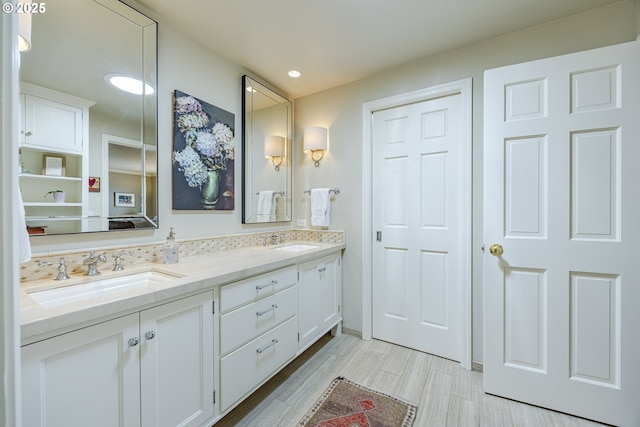 bathroom featuring double vanity and recessed lighting