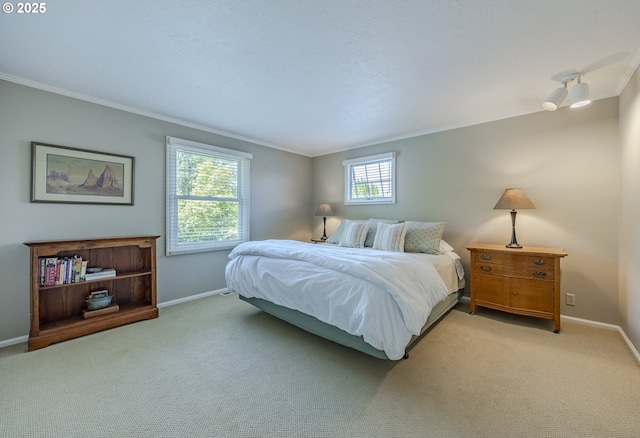 bedroom featuring crown molding, baseboards, and light carpet