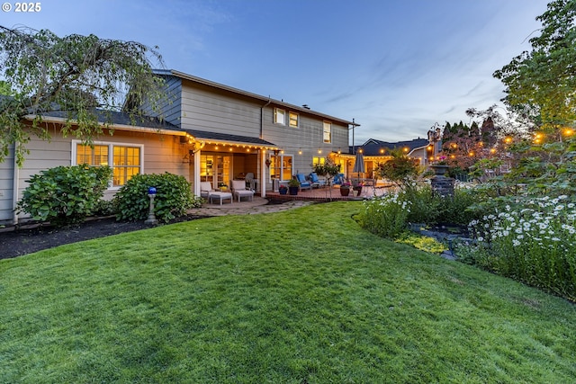 rear view of property featuring a patio area and a yard