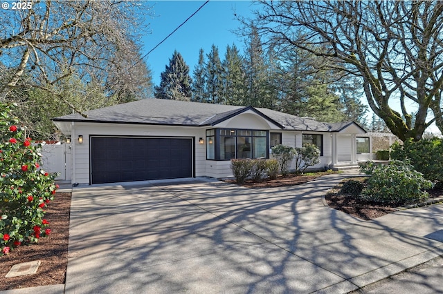 single story home with driveway and an attached garage