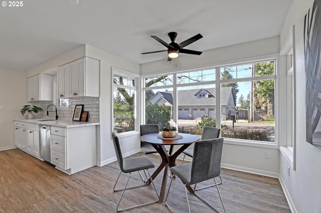 dining room with plenty of natural light, baseboards, and wood finished floors