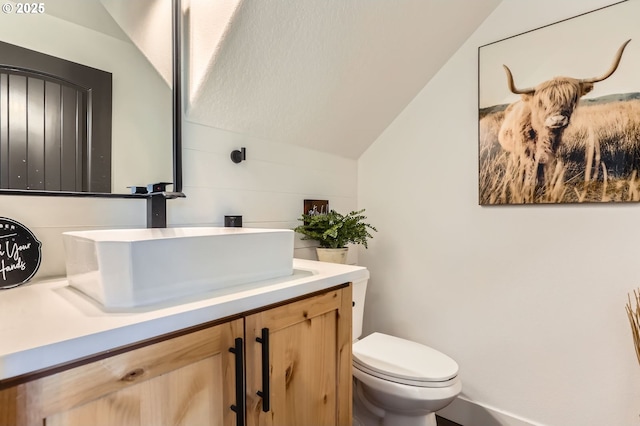 1028 E 16th St, Lafayette, OR 97127 - bathroom featuring lofted ceiling, vanity, and toilet