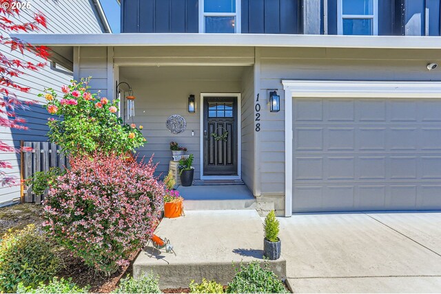 1028 E 16th St, Lafayette, OR 97127 - view of exterior entry with an attached garage and board and batten siding