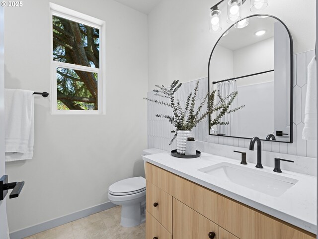 1616 SE Morrison St, Portland, OR 97214 - full bathroom featuring vanity, toilet, plenty of natural light, and baseboards