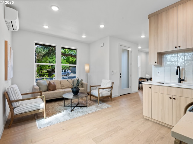 1616 SE Morrison St, Portland, OR 97214 - living room featuring a wall unit AC, light wood-style floors, baseboards, and recessed lighting