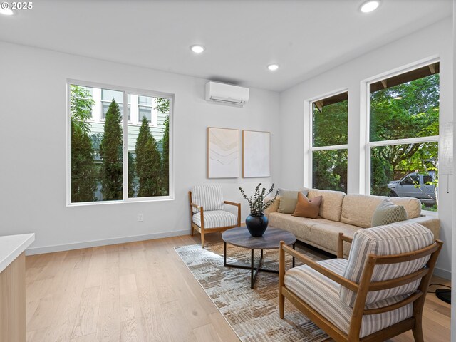 1616 SE Morrison St, Portland, OR 97214 - living room featuring a wall unit AC, healthy amount of natural light, light wood-style flooring, recessed lighting, and baseboards