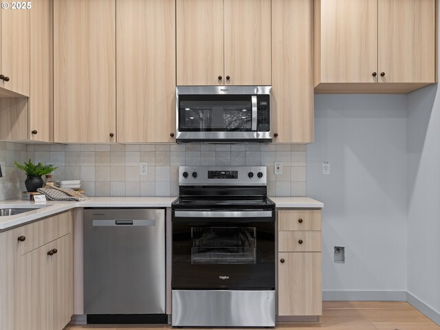 1616 SE Morrison St, Portland, OR 97214 - kitchen featuring stainless steel appliances and light brown cabinetry