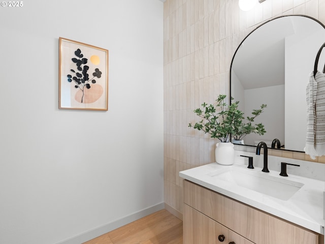 1616 SE Morrison St, Portland, OR 97214 - bathroom featuring vanity, tile walls, wood finished floors, and baseboards