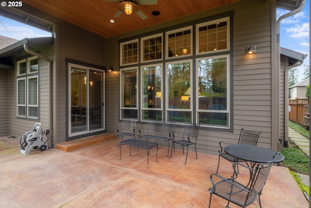 view of patio with a ceiling fan and fence