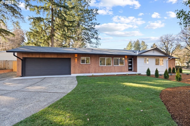 ranch-style house featuring a garage and a front lawn