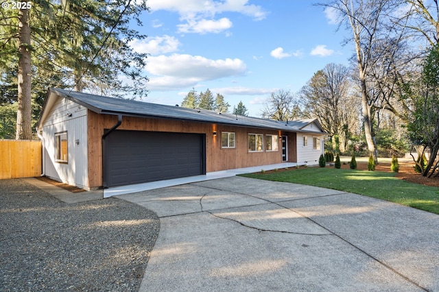 single story home with a garage and a front lawn