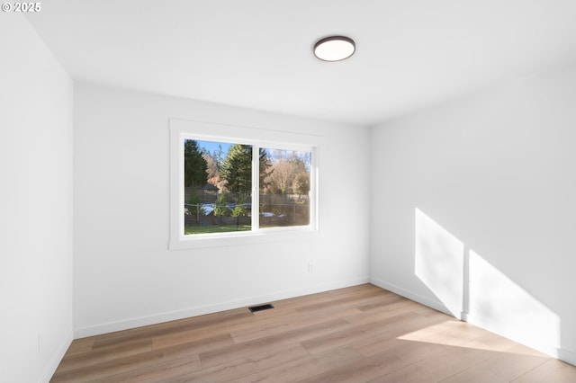 unfurnished room with light wood-type flooring