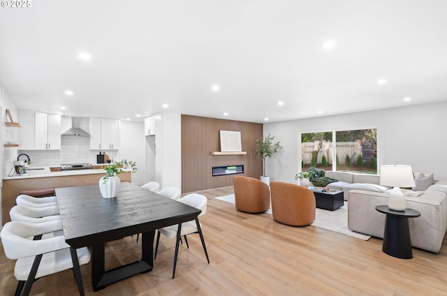 dining space featuring sink and light wood-type flooring