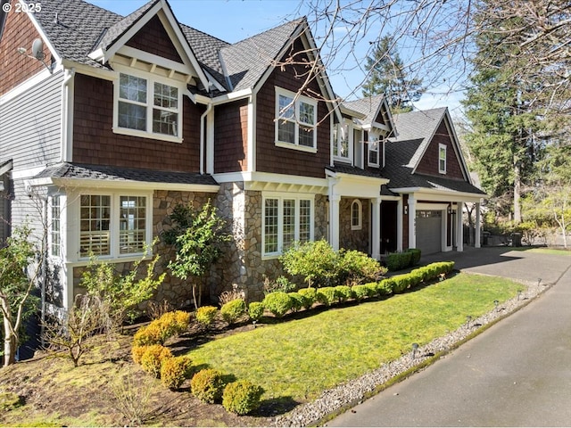 9037 NW Murdock St, Portland, OR 97229 - shingle-style home with stone siding, asphalt driveway, a front yard, an attached garage, and roof with shingles