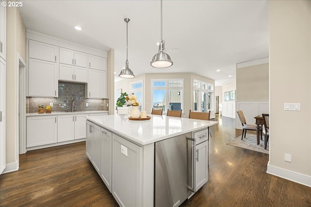 9037 NW Murdock St, Portland, OR 97229 - kitchen with dark wood-style flooring, fridge, decorative backsplash, white cabinets, and decorative light fixtures