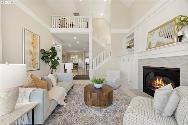 9037 NW Murdock St, Portland, OR 97229 - living area with a fireplace, stairway, a high ceiling, and recessed lighting