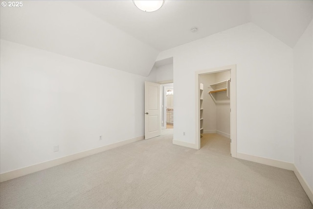 9037 NW Murdock St, Portland, OR 97229 - unfurnished bedroom with lofted ceiling, light carpet, a walk in closet, baseboards, and a closet
