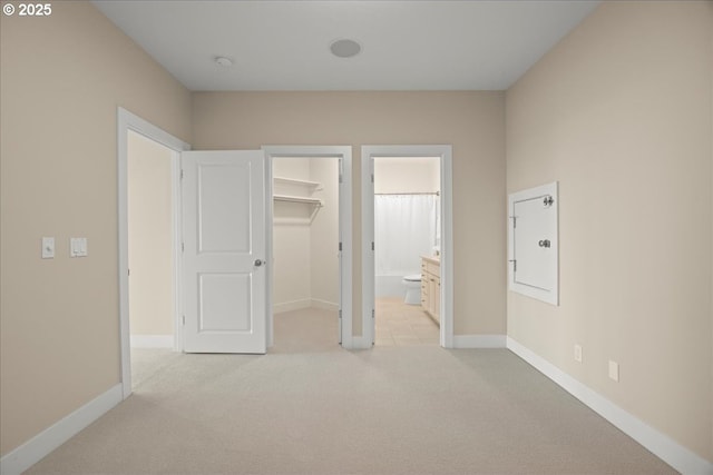 9037 NW Murdock St, Portland, OR 97229 - unfurnished bedroom with light colored carpet, a spacious closet, baseboards, and a closet