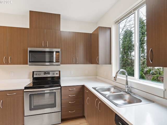 kitchen featuring stainless steel appliances, a healthy amount of sunlight, and sink