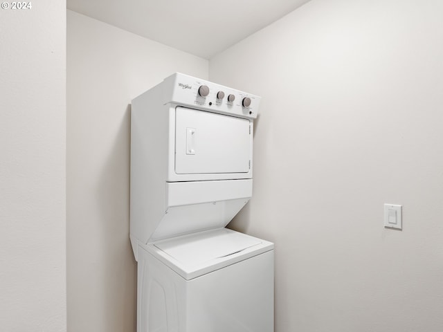 laundry area with stacked washing maching and dryer