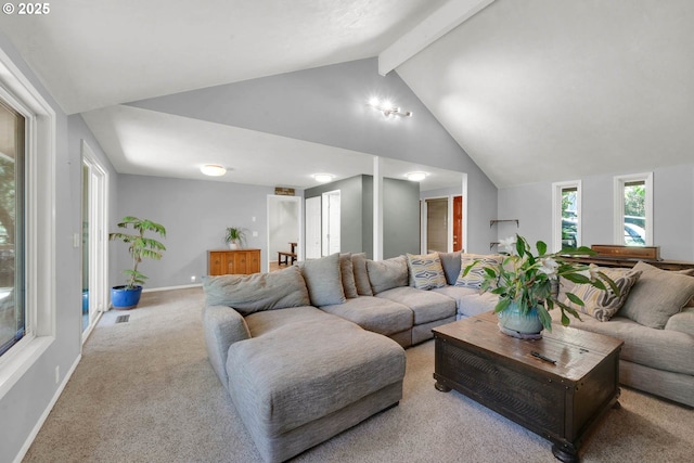 living room featuring lofted ceiling with beams and light colored carpet