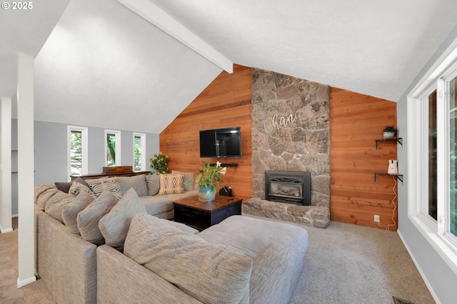 living room with a stone fireplace, wood walls, lofted ceiling with beams, and carpet