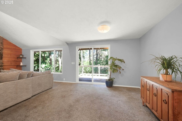 carpeted living room with vaulted ceiling