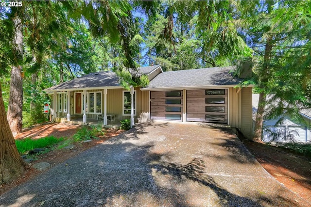 single story home featuring a garage and covered porch