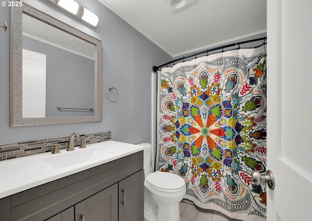 bathroom featuring a textured ceiling, vanity, decorative backsplash, toilet, and crown molding