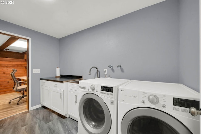 laundry room with sink, washer and clothes dryer, dark wood-type flooring, and cabinets