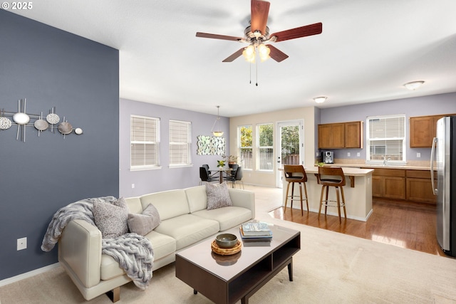 18646 SW Hideo Ct, Beaverton, OR 97003 - living room featuring ceiling fan, light wood-style floors, and baseboards