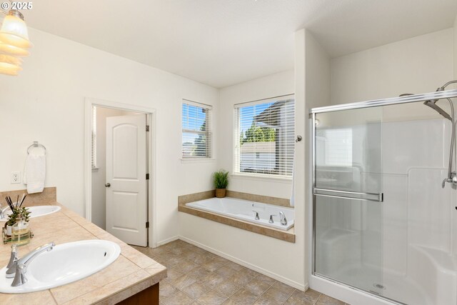 18646 SW Hideo Ct, Beaverton, OR 97003 - bathroom featuring a shower stall, a bath, double vanity, and baseboards