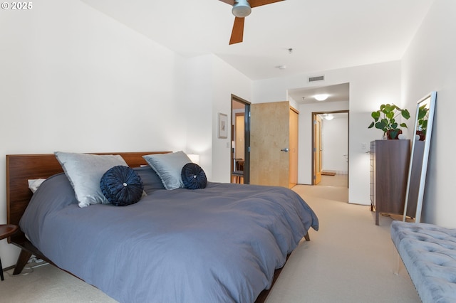 carpeted bedroom featuring ceiling fan and connected bathroom