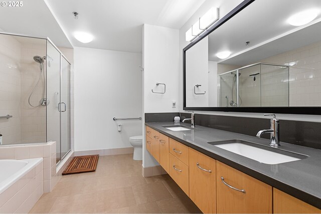 full bathroom featuring tile patterned flooring, vanity, toilet, and independent shower and bath