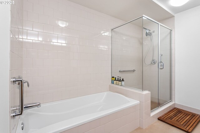 bathroom with tile patterned flooring and independent shower and bath