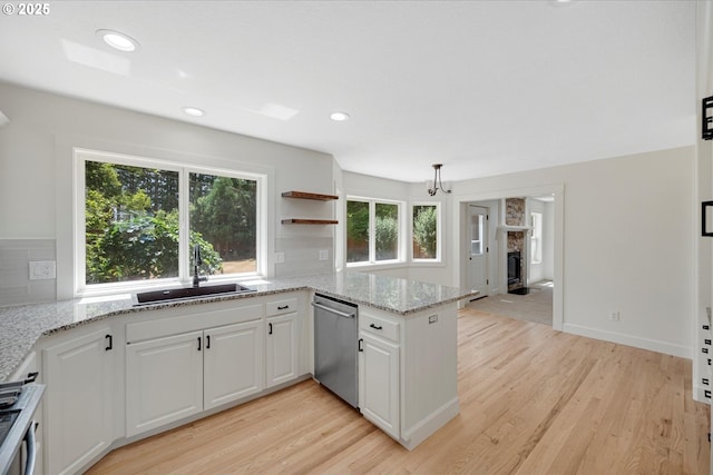 9240 SW Stono Dr, Tualatin, OR 97062 - kitchen featuring stainless steel dishwasher, a peninsula, light wood-style floors, decorative backsplash, and recessed lighting