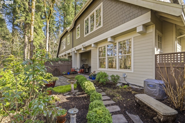 view of property exterior with a patio area and fence