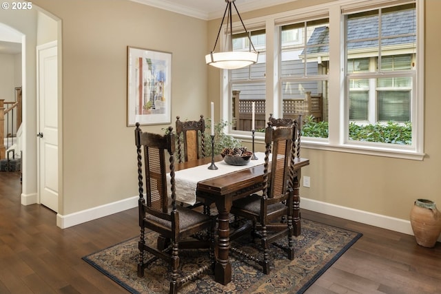 dining space featuring baseboards, arched walkways, dark wood-style floors, and crown molding