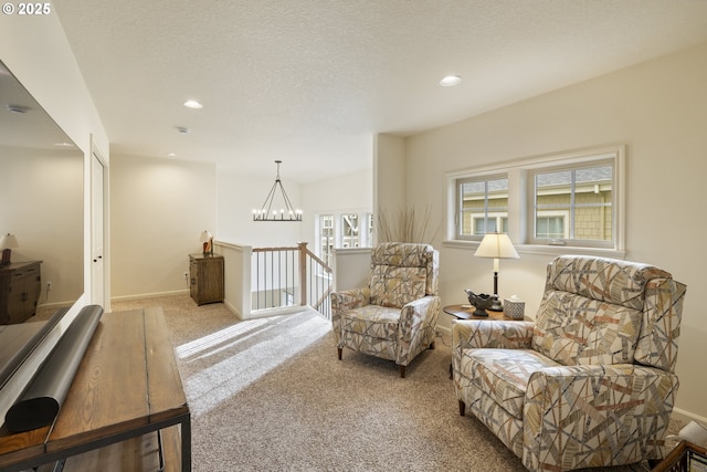 sitting room with a textured ceiling, recessed lighting, an inviting chandelier, carpet flooring, and baseboards