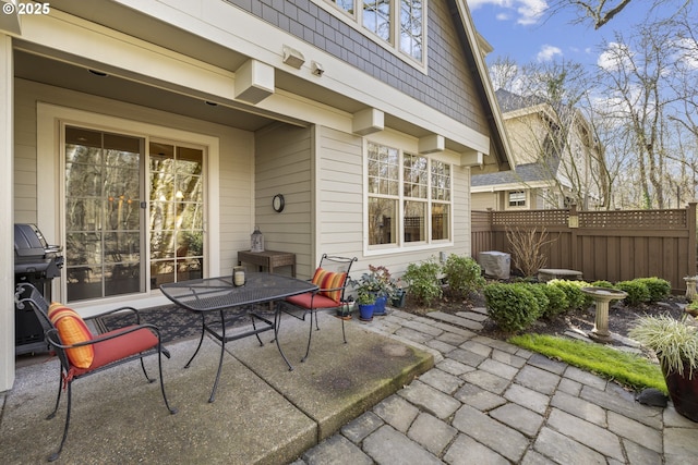 view of patio / terrace with outdoor dining area, grilling area, and fence