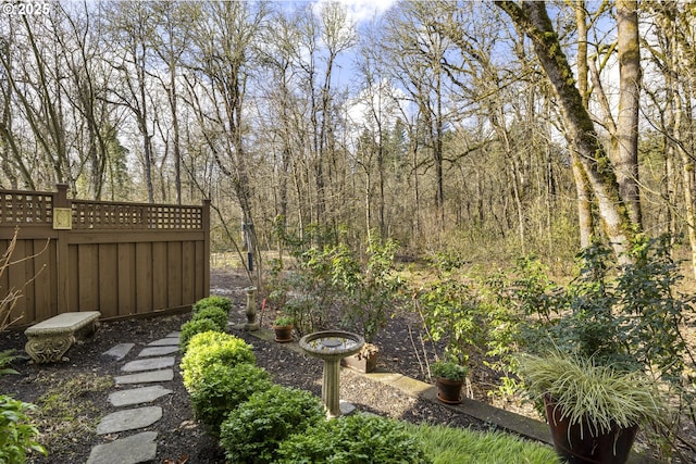 view of yard featuring a forest view