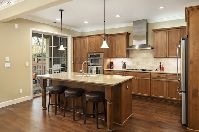 kitchen featuring stainless steel appliances, brown cabinets, dark wood-type flooring, and wall chimney exhaust hood