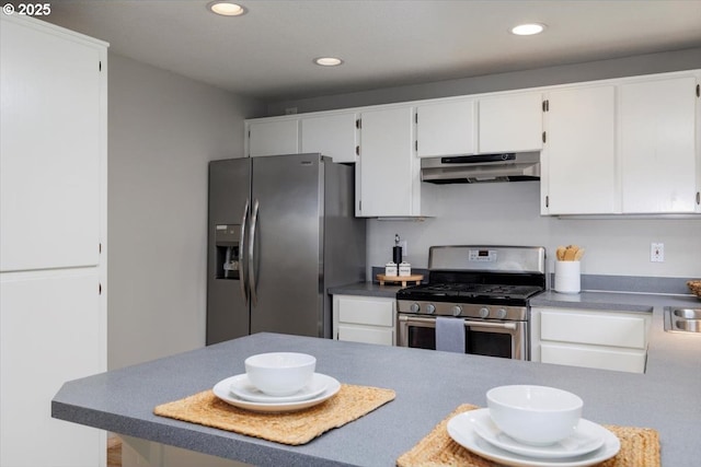 kitchen with appliances with stainless steel finishes, under cabinet range hood, recessed lighting, and white cabinetry