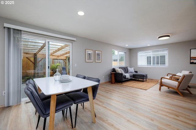 dining room featuring light wood-style flooring, recessed lighting, and baseboards