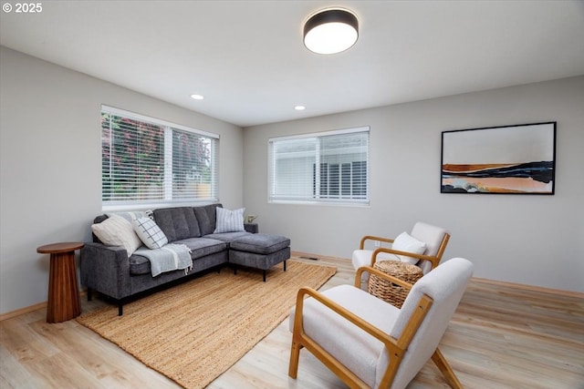 living area with light wood-style floors and recessed lighting